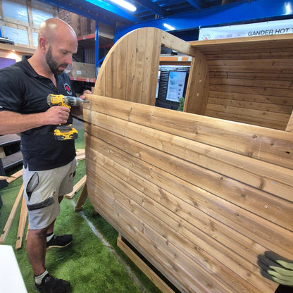 Technician assembling outdoor barrel sauna